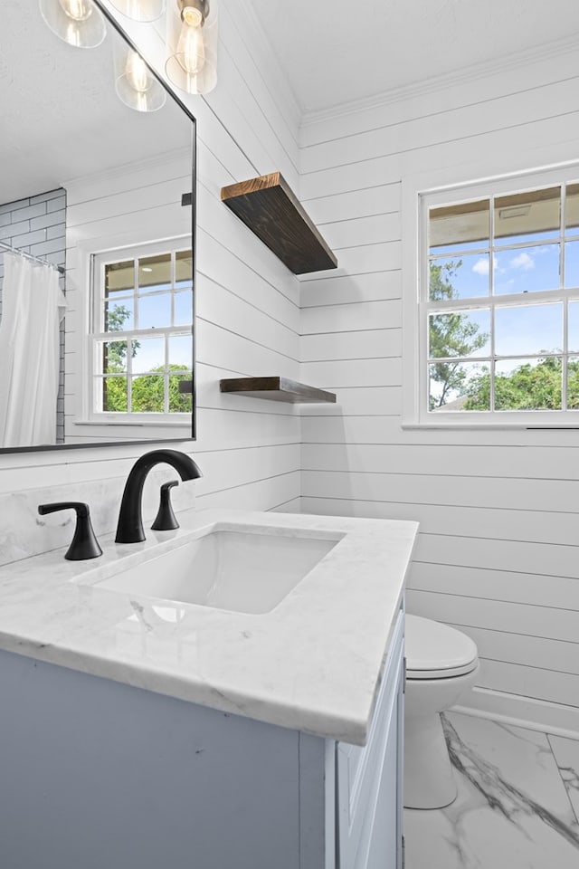 full bathroom with wood walls, vanity, toilet, marble finish floor, and ornamental molding