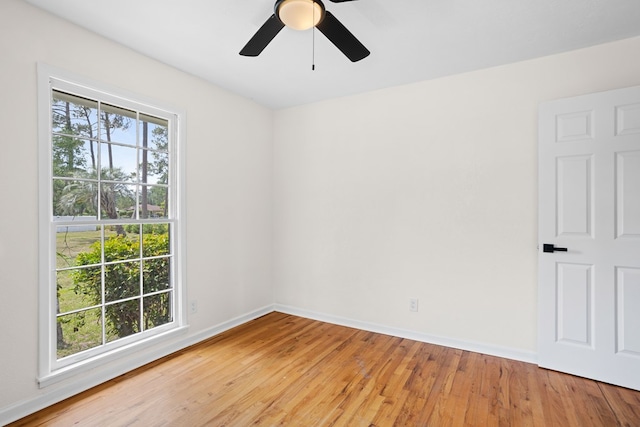 empty room with baseboards, light wood-style flooring, and ceiling fan