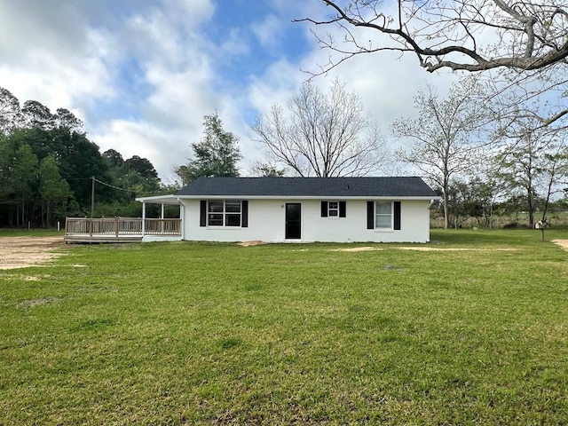 view of front of house with a front lawn, a wooden deck, and stucco siding