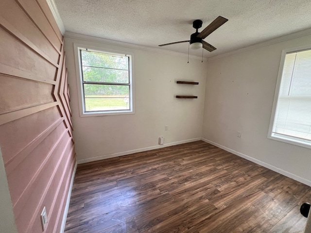 unfurnished room featuring dark wood-style floors, a textured ceiling, ornamental molding, and a ceiling fan