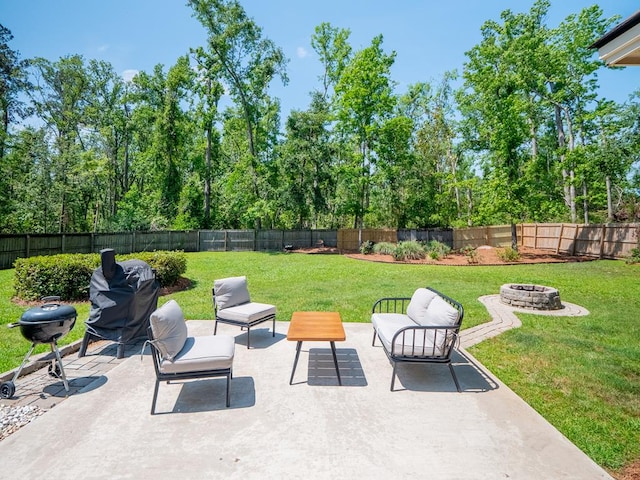 view of patio / terrace with a fire pit, a fenced backyard, and grilling area