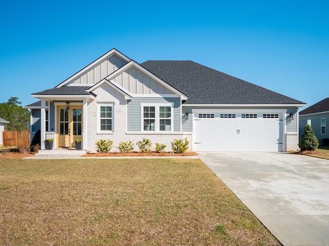 craftsman-style home with driveway, brick siding, board and batten siding, and a front lawn