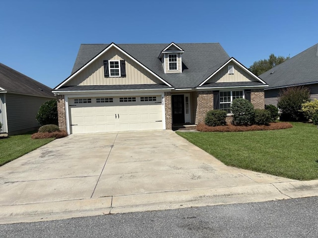 view of front of property with a front lawn and a garage