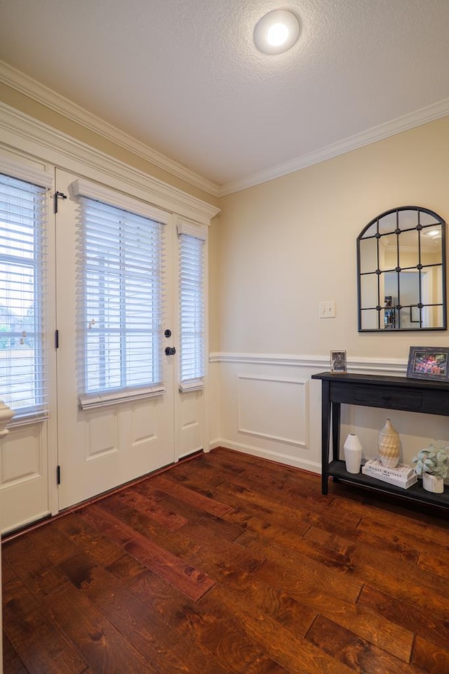 doorway featuring a wealth of natural light, crown molding, and dark wood-type flooring