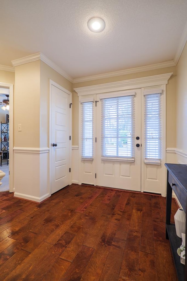 doorway with ornamental molding, ceiling fan, a textured ceiling, and dark hardwood / wood-style floors