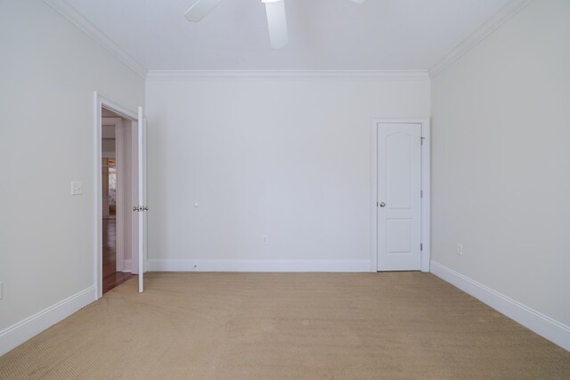 unfurnished room with ceiling fan, light colored carpet, and ornamental molding