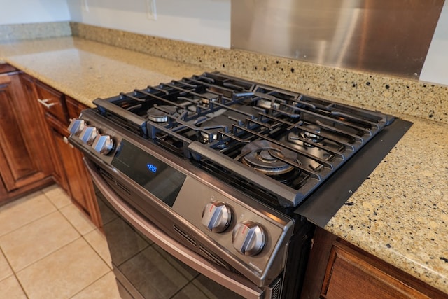 room details with stainless steel gas stove and light stone counters