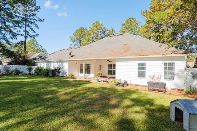 back of property featuring a lawn, ceiling fan, and a patio