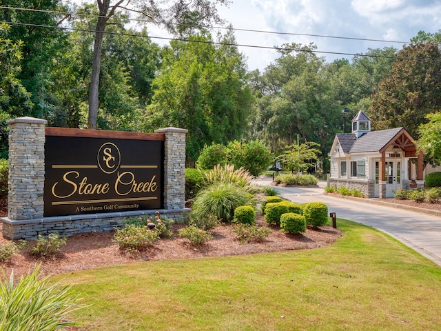 community sign featuring a lawn