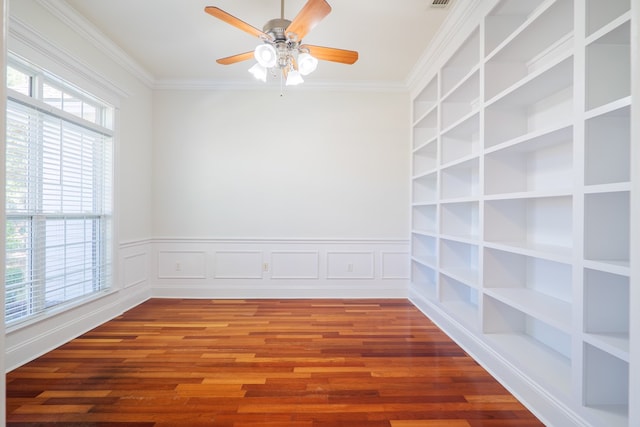 empty room with ceiling fan, wood-type flooring, and ornamental molding