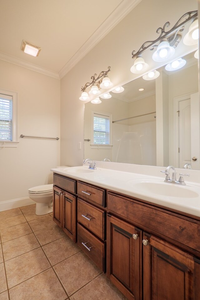 bathroom featuring walk in shower, vanity, crown molding, tile patterned flooring, and toilet