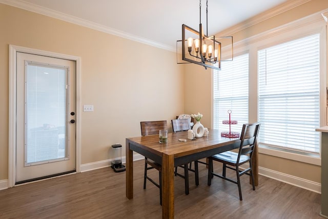 dining space with an inviting chandelier, dark hardwood / wood-style flooring, and ornamental molding