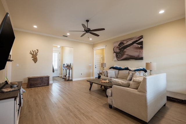 living room featuring ceiling fan, wood-type flooring, and ornamental molding