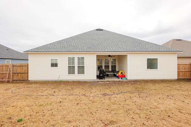 back of property with ceiling fan and a patio area