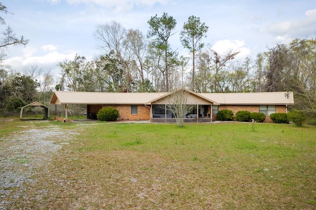 ranch-style home with a carport and a front lawn