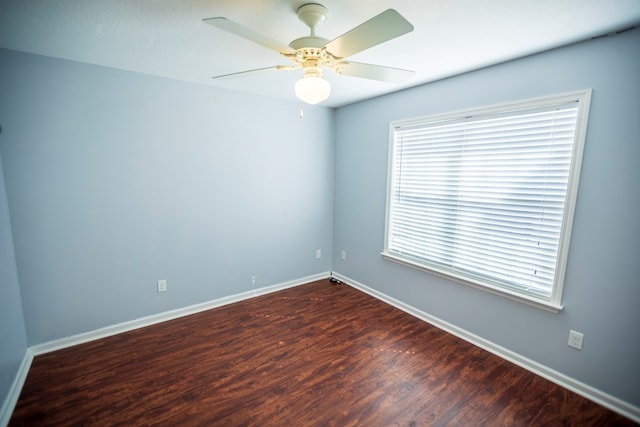 unfurnished room with dark wood-type flooring and ceiling fan