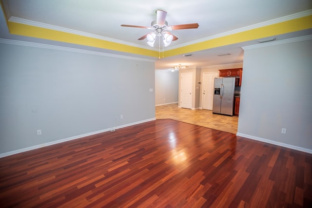 empty room with dark wood-type flooring, ceiling fan, and ornamental molding