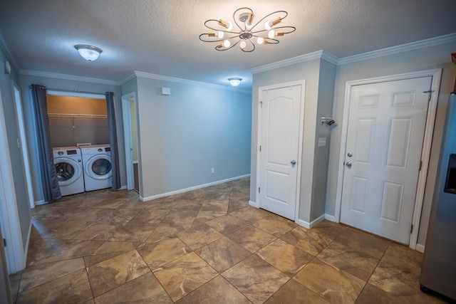 laundry area featuring an inviting chandelier, crown molding, washer and dryer, and a textured ceiling