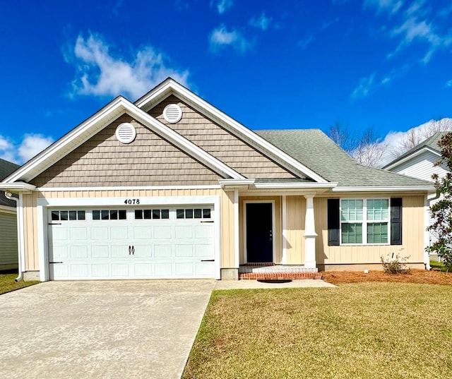 craftsman inspired home featuring a garage and a front yard