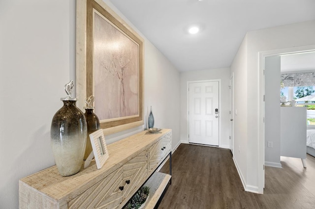 interior space featuring baseboards and dark wood finished floors