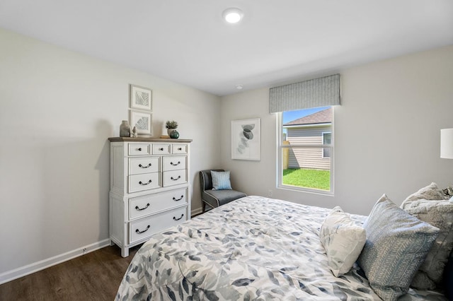 bedroom featuring dark wood-style floors and baseboards