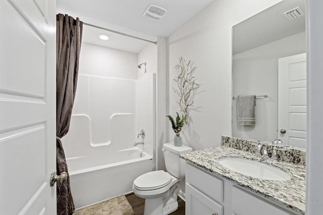 full bathroom with toilet, shower / bath combo, vanity, and visible vents