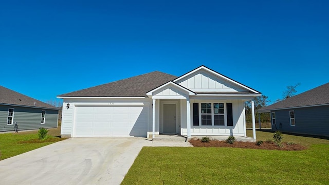 view of front of house featuring roof with shingles, concrete driveway, board and batten siding, a garage, and a front lawn