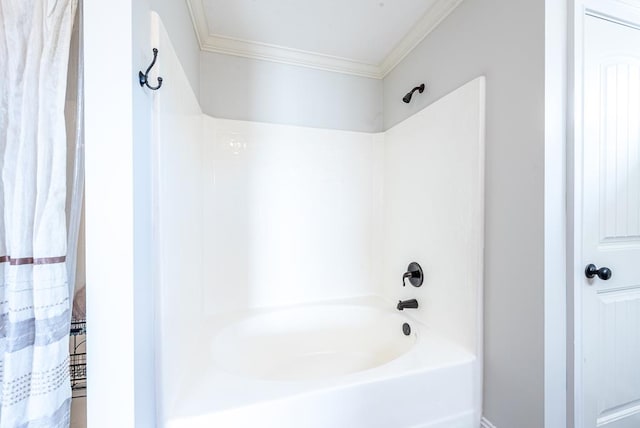 bathroom with shower / tub combo with curtain and ornamental molding