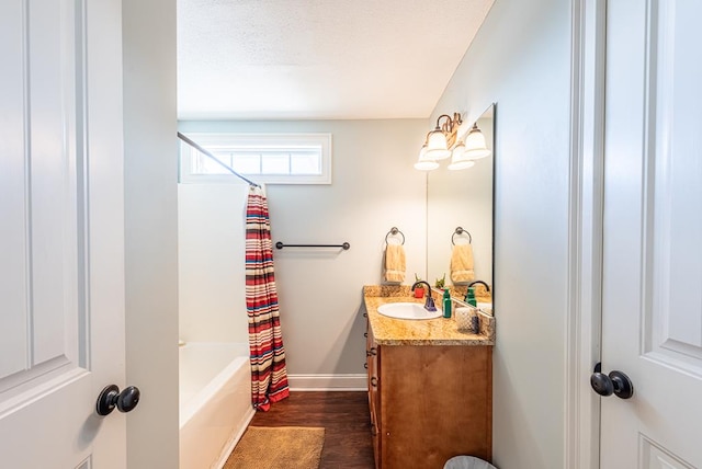 bathroom featuring vanity, hardwood / wood-style flooring, and shower / bath combo with shower curtain