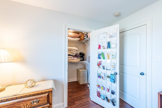 bedroom with dark wood-type flooring and a closet