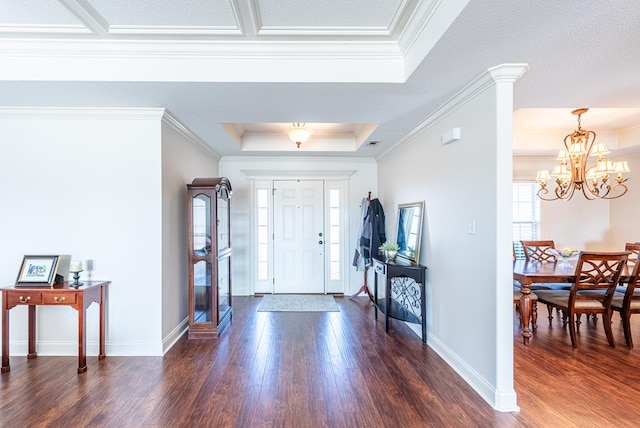 foyer featuring ornamental molding, a tray ceiling, and dark wood-style flooring