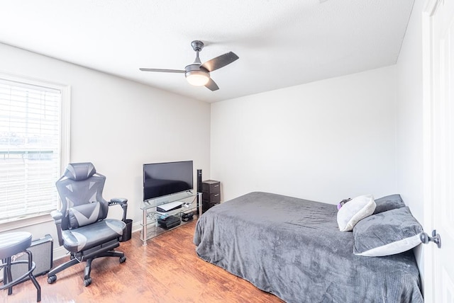 bedroom featuring ceiling fan and hardwood / wood-style flooring