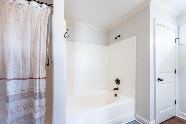 bathroom featuring hardwood / wood-style floors, crown molding, and shower / tub combo with curtain