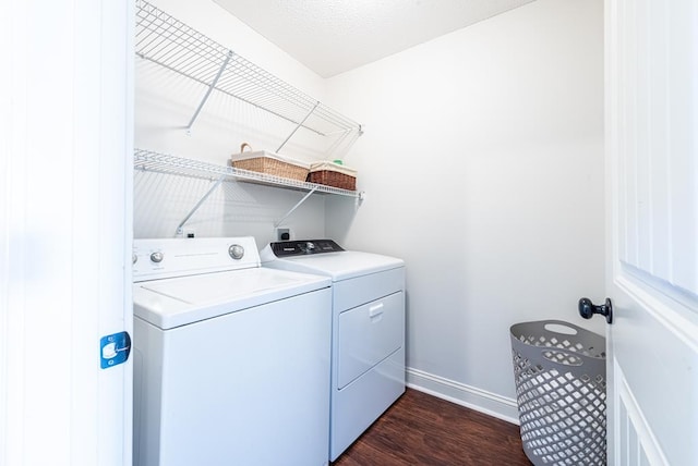 laundry room with washer and clothes dryer and dark hardwood / wood-style floors