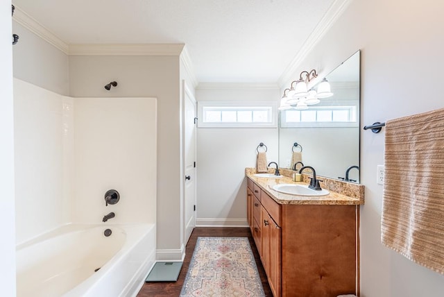 bathroom featuring crown molding, vanity, and washtub / shower combination