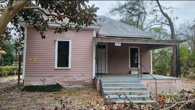 back of property featuring a porch