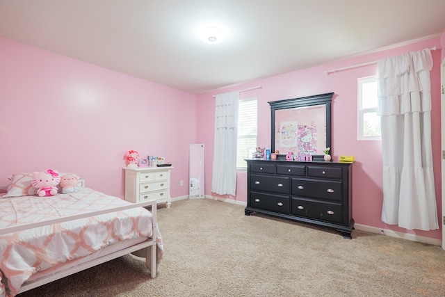 bedroom featuring light colored carpet and baseboards