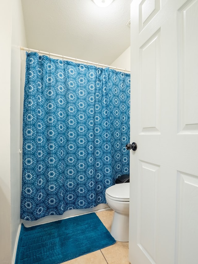 bathroom featuring tile patterned flooring and toilet