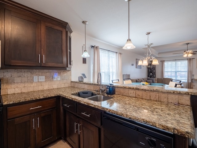 kitchen featuring pendant lighting, sink, kitchen peninsula, and black dishwasher