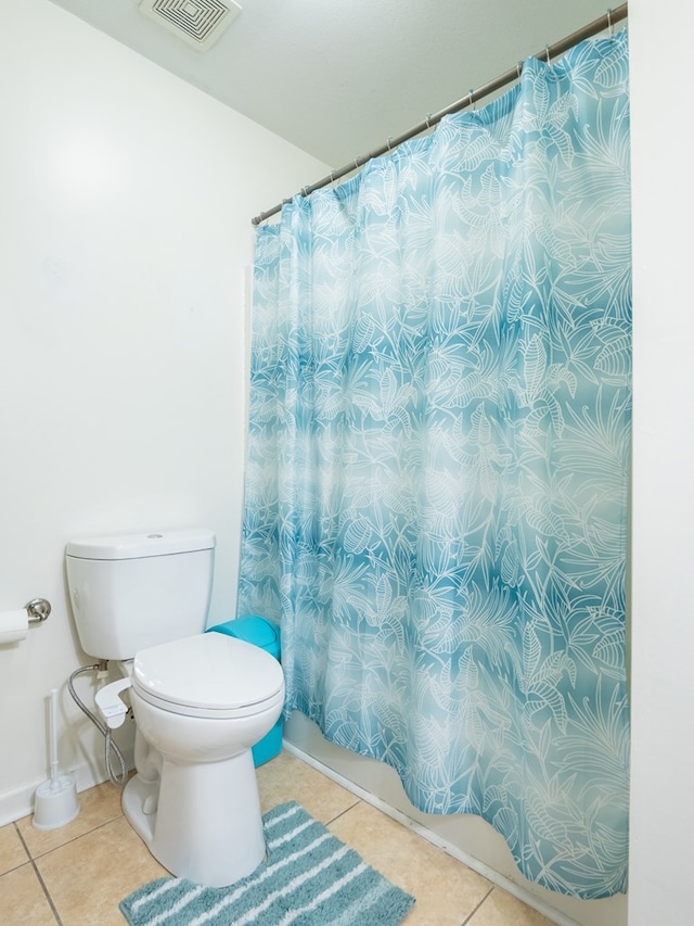 bathroom with tile patterned flooring and toilet