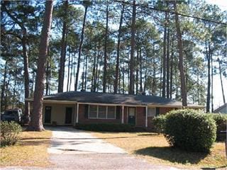 ranch-style house featuring driveway and a carport