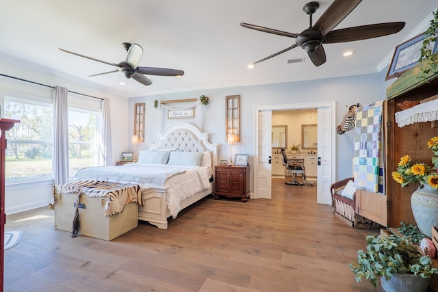 bedroom with light wood-type flooring, ceiling fan, and ornamental molding