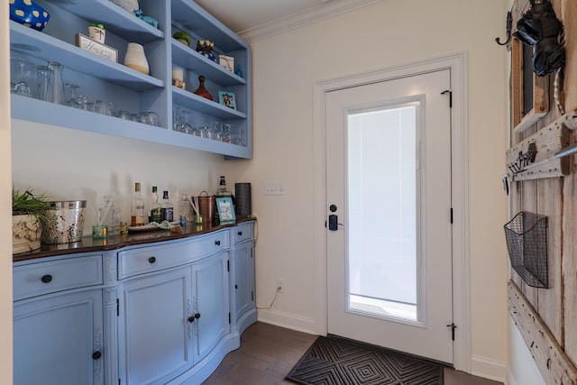 bar featuring crown molding and dark hardwood / wood-style floors