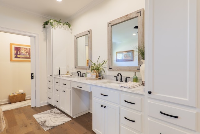 bathroom with vanity, hardwood / wood-style flooring, and crown molding