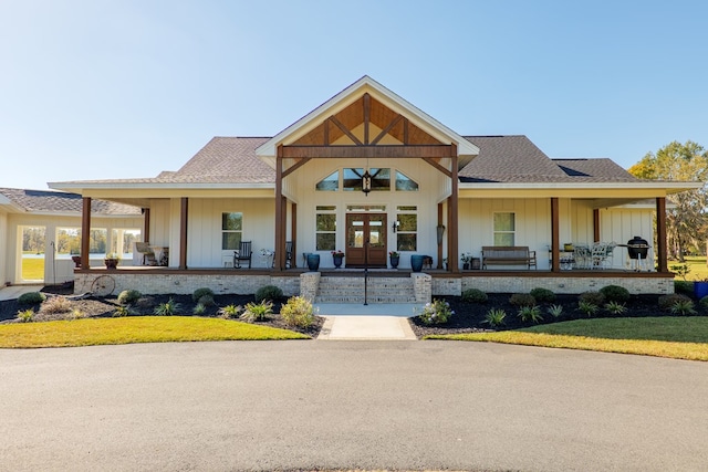 view of front facade featuring a porch and french doors