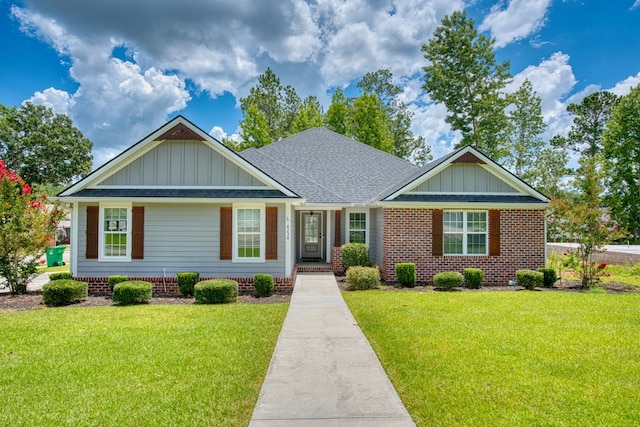 4234 Whithorn Way, Valdosta, GA 31605 - view of front of house with board and batten siding, a front lawn, and roof with shingles