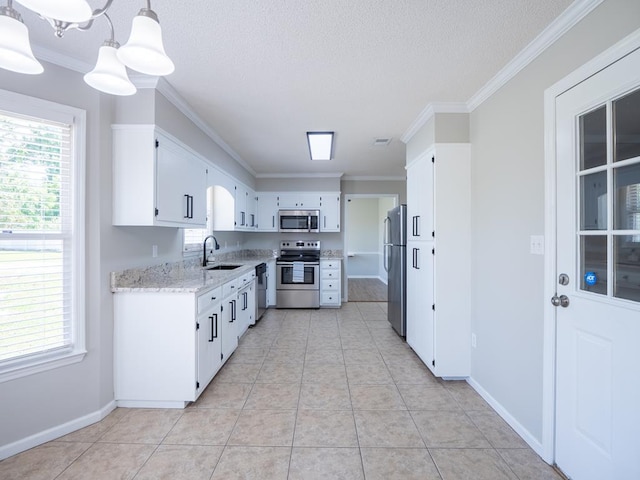 3875 Studstill Rd, Valdosta, GA 31605 - kitchen featuring stainless steel appliances, crown molding, healthy amount of natural light, light stone counters, and white cabinetry