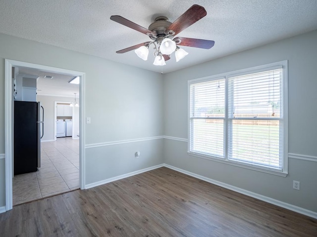 3875 Studstill Rd, Valdosta, GA 31605 - empty room featuring washer and dryer, wood finished floors, ceiling fan, baseboards, and a textured ceiling