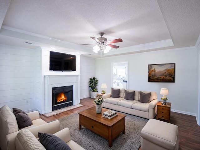 3875 Studstill Rd, Valdosta, GA 31605 - living area with wood finished floors, ornamental molding, ceiling fan, a textured ceiling, and a fireplace