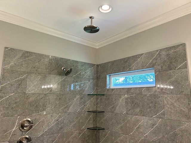 bathroom with a tile shower and ornamental molding